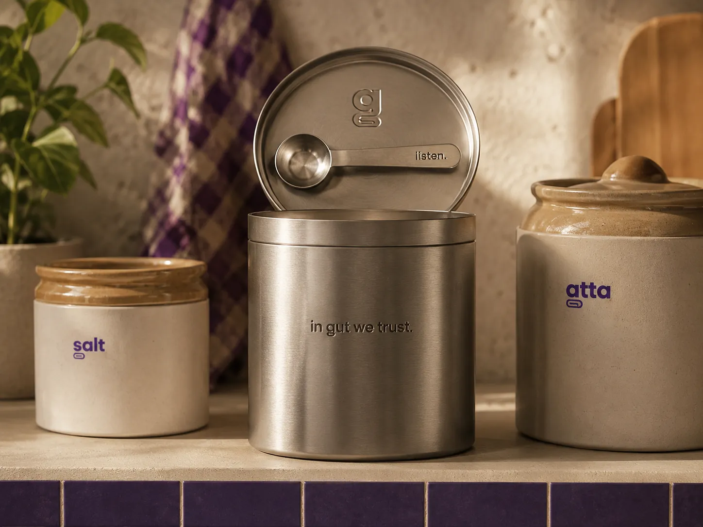the keeper tin, an engraved steel canister with its dosing spoon